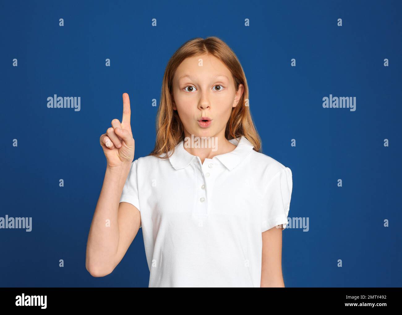Portrait of emotional preteen girl on blue background Stock Photo - Alamy