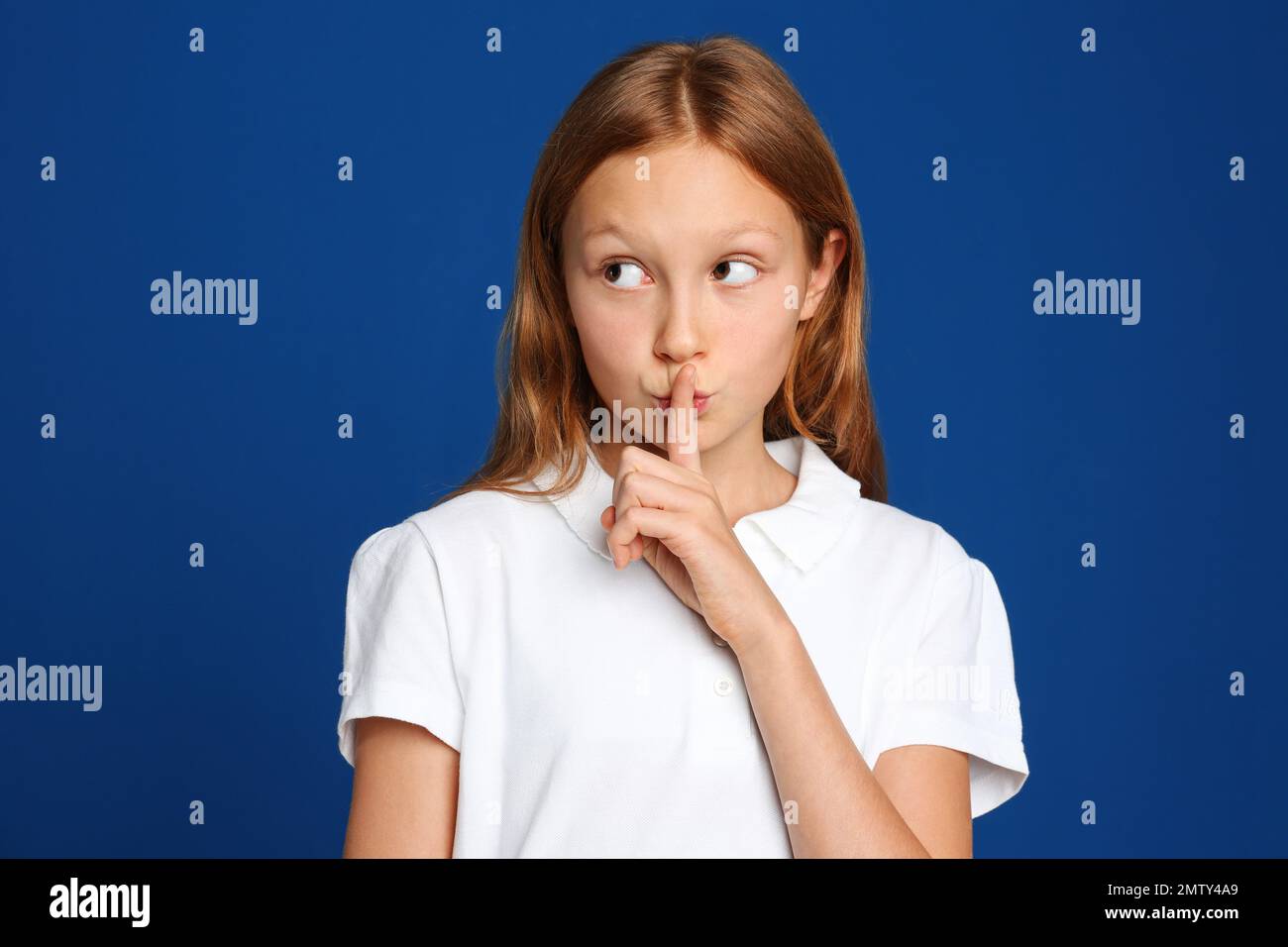 Portrait of emotional preteen girl on blue background Stock Photo - Alamy