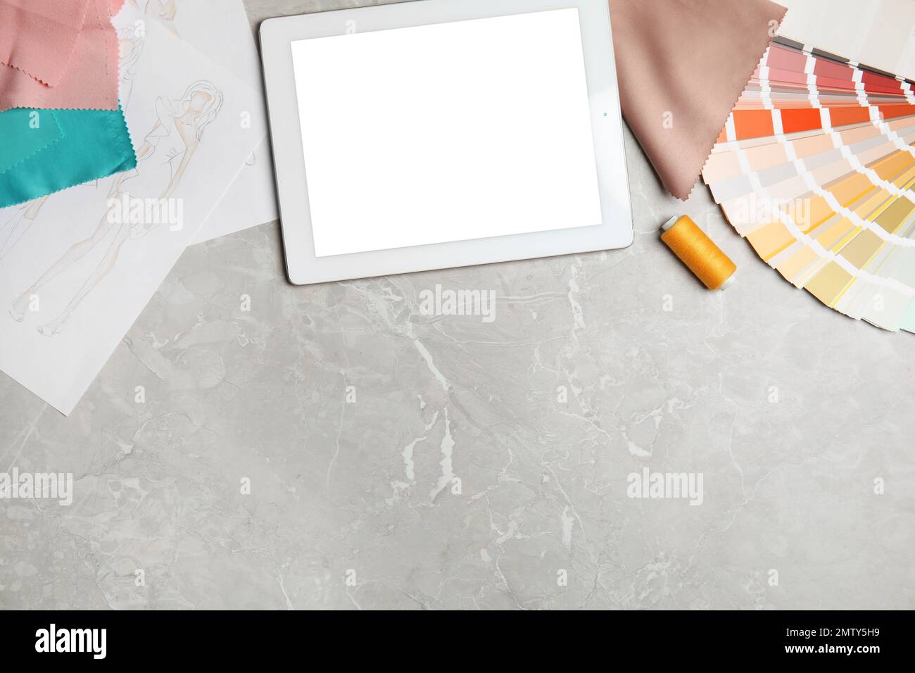 Flat lay composition with tablet and palette on grey marble table ...