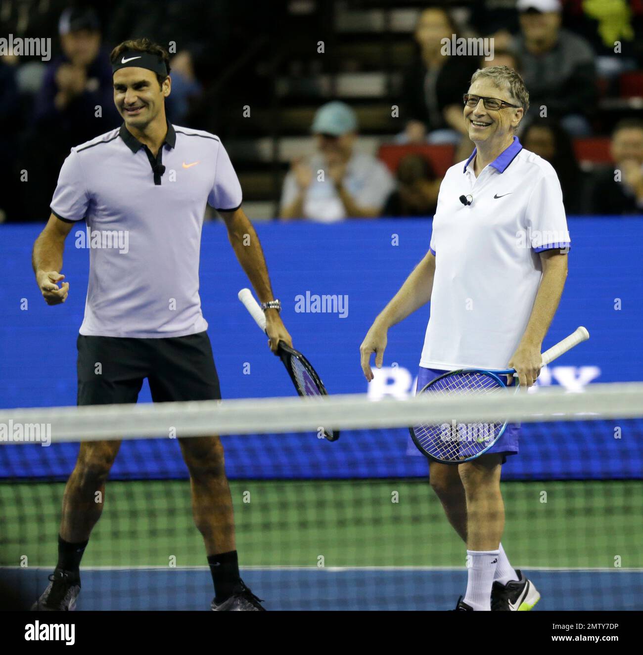 Roger Federer, of Switzerland, left, stands with his doubles partner,  Microsoft founder Bill Gates, right, during an exhibition tennis match,  Saturday, April 29, 2017, in Seattle. The Match for Africa 4 was
