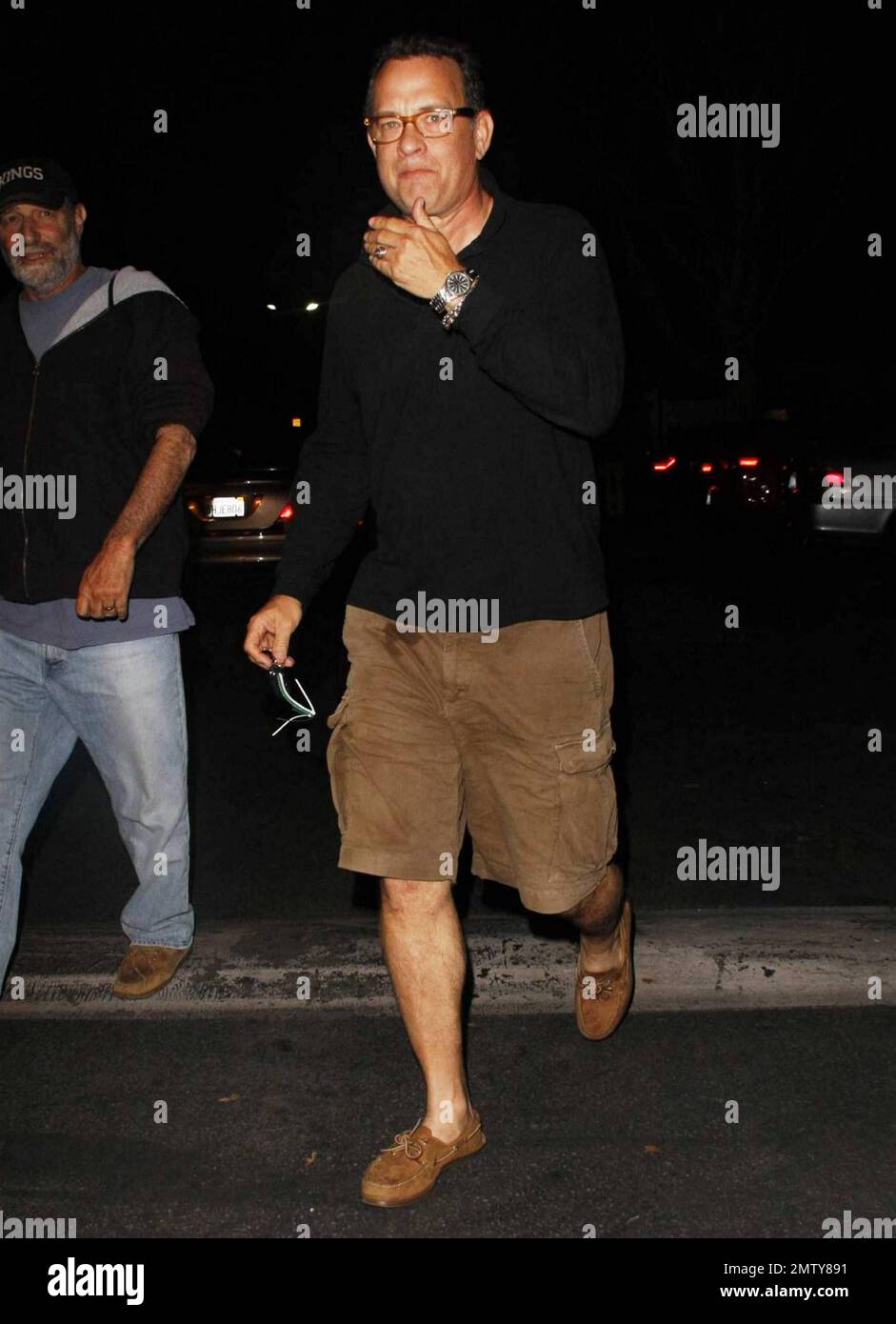 Oscar winning actor, producer, director and writer Tom Hanks leaves the Malibu Cinema with some friends showing off a stain on his pants.  Hanks is currently working on a new comedy, 'Larry Crowne' due out in 2011 which he wrote, produced, directed and starred in. Los Angeles, CA. 07/17/10. Stock Photo