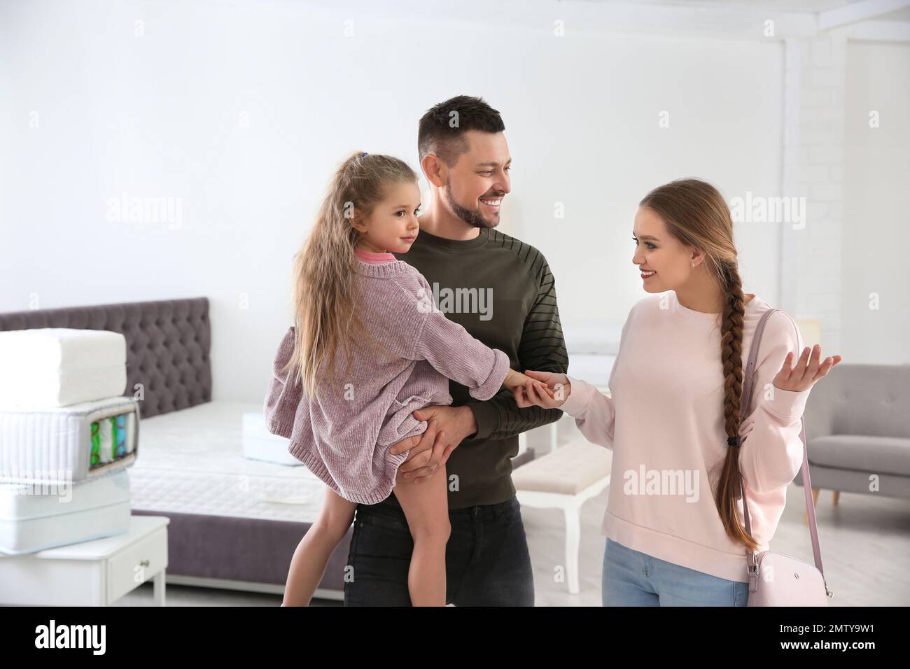 Happy family looking for mattress in furniture store Stock Photo