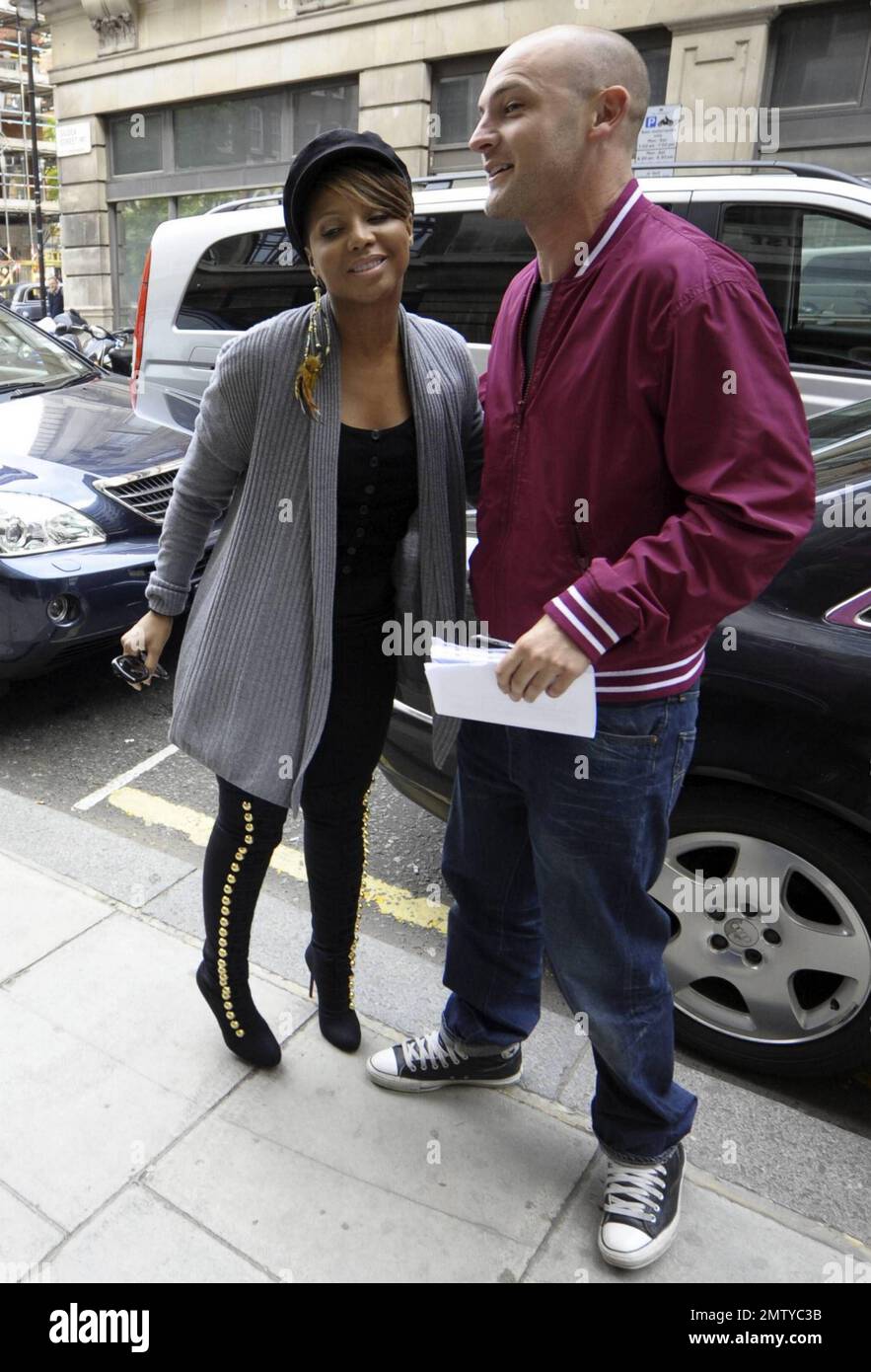 Singer Toni Braxton wears an all-black outfit of leggings, knee-high boots, leather jacket and hat as she arrives for an appearance at the BBC. Braxton greeted fans as she arrived, accompanied by bodyguards. London, UK. 5/12/10. Stock Photo