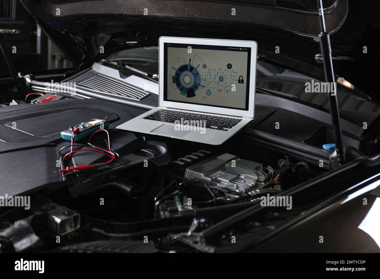 Laptop with diagram on auto engine. Modern car diagnostic Stock Photo
