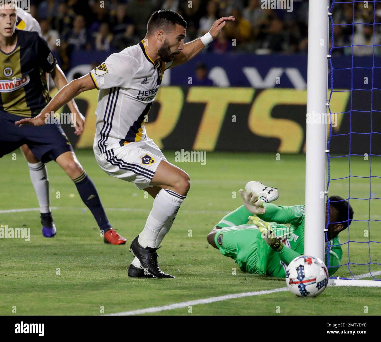Philadelphia Union goalkeeper Andre Blake, right, blocks a shot by LA ...