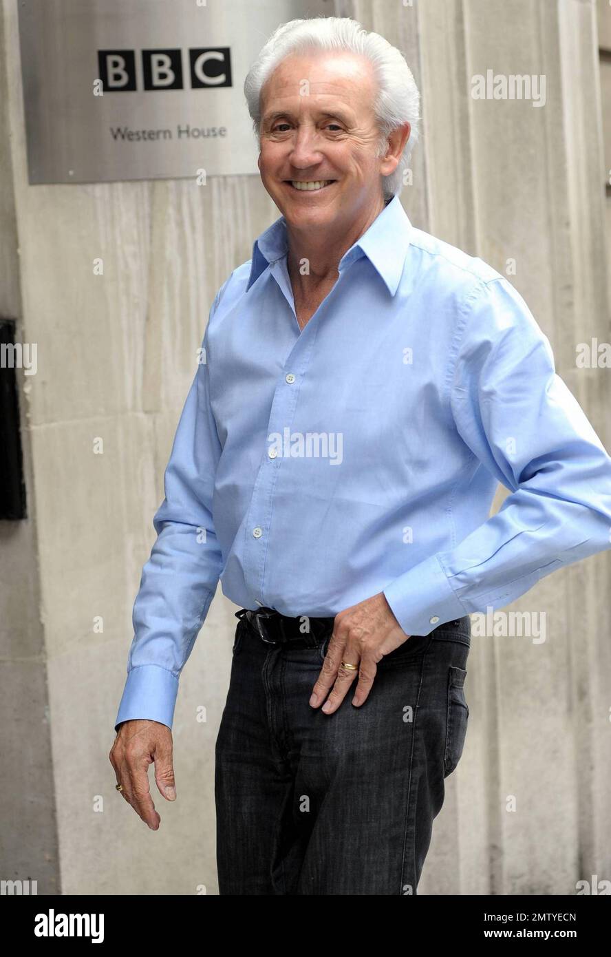 Singer Tony Christie is all smiles as he poses for photos while arriving at BBC Radio 2 for an appearance. London, UK. 7/7/10. Stock Photo