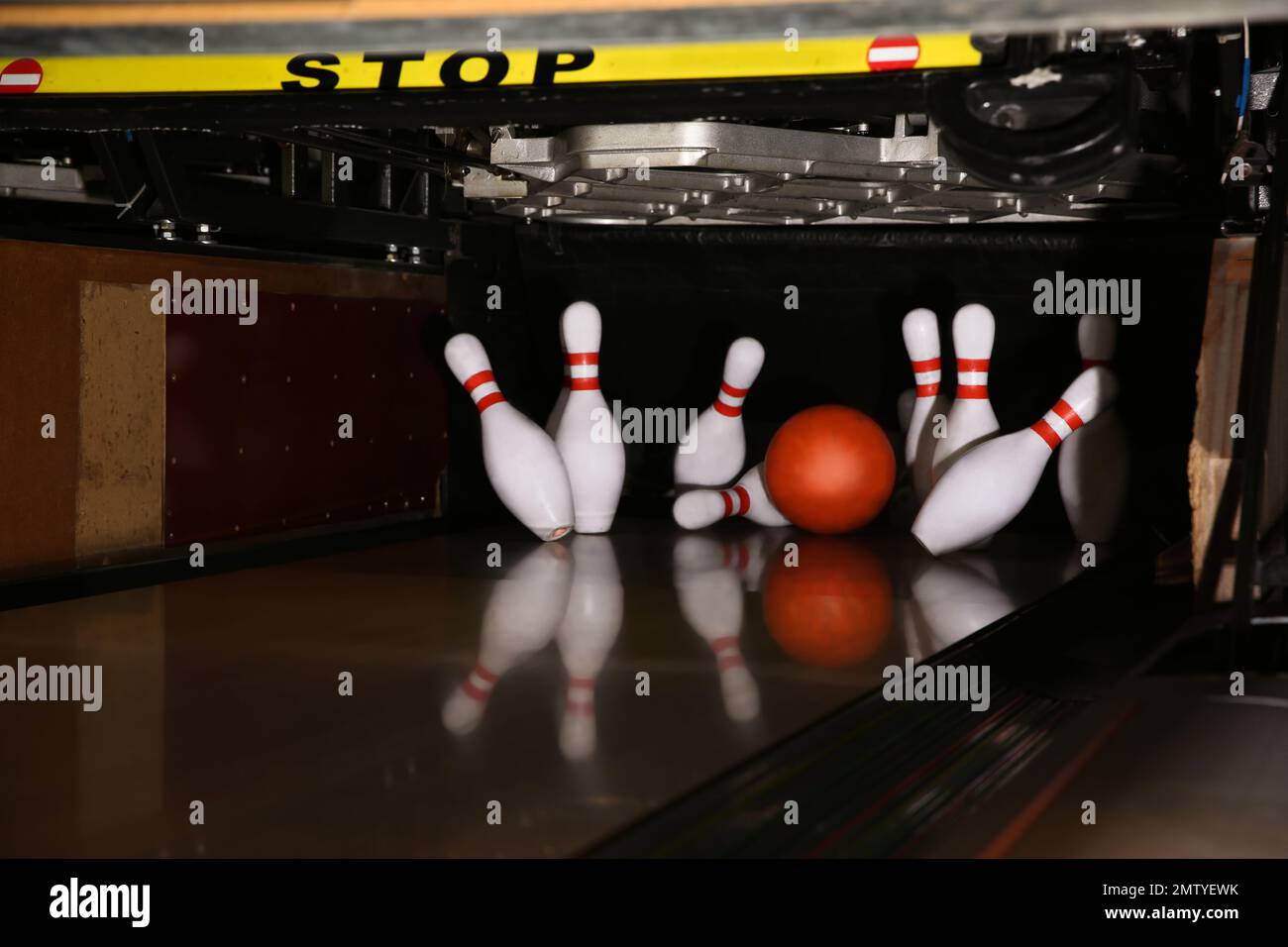Ball hitting pins on alley in bowling club Stock Photo Alamy