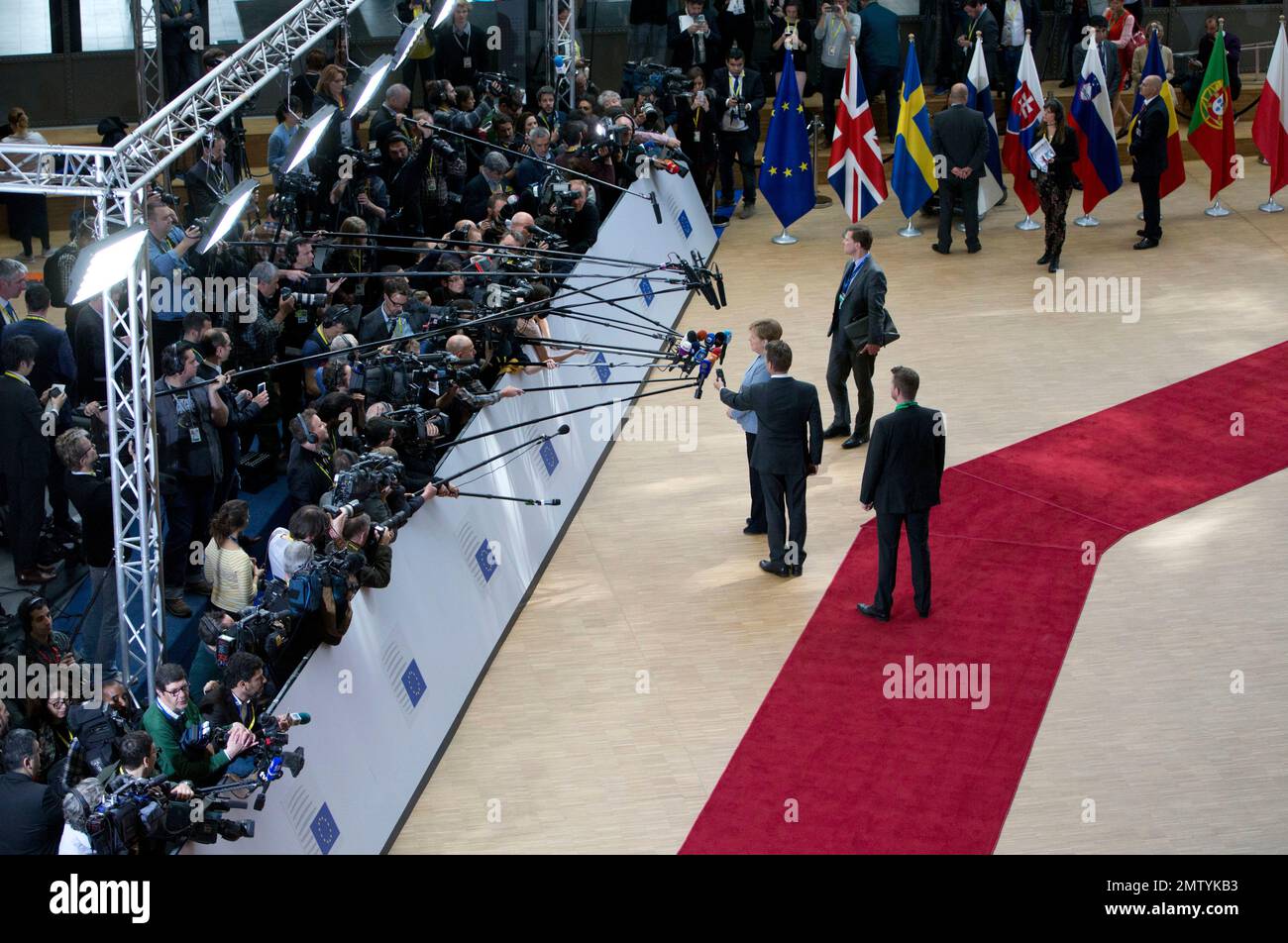 German Chancellor Angela Merkel, center, speaks with the media as she