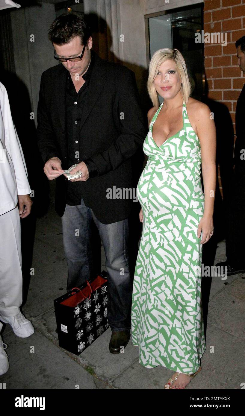 Pregnant actress Tori Spelling signs autographs as she leaves the