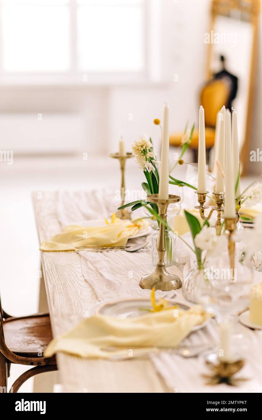 Beautiful Easter table setting with floral decor indoors Stock Photo