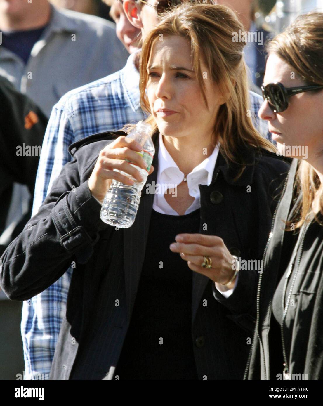 Actress Tea Leoni, who appears to play a police officer, points a prop