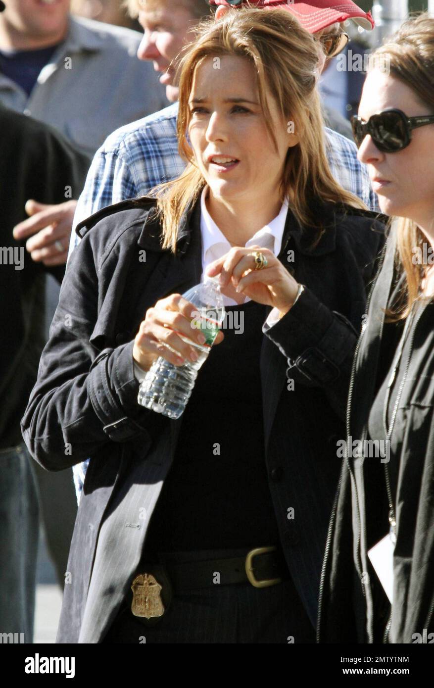 Actress Tea Leoni, who appears to play a police officer, points a prop