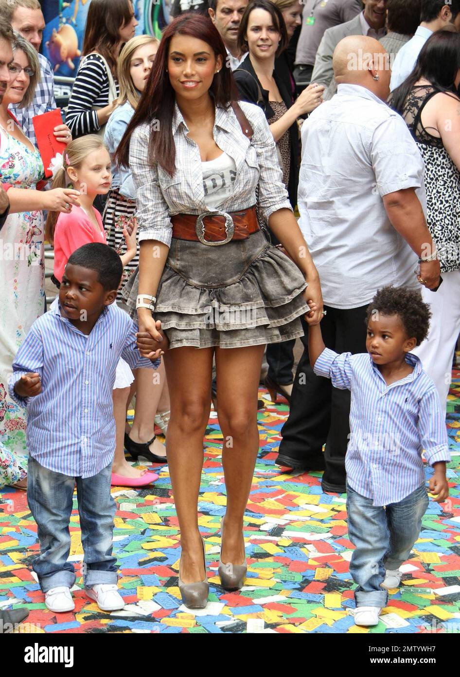 Chantelle Tagoe, fiancee of English footballer Emile Heskey, walks the multicolor carpet with her and Heskey's children at Empire Leicester Square for the UK premiere of Disney and Pixar's 'Toy Story 3'.  The third installment in the Toy Story series has so far received positive reviews since its June release in North America and has proved popular in the toy and video game world with Mattel, Wii, Xbox 360 and PS3 all creating products based on the lovable film characters. London, UK. 07/18/10.    . Stock Photo