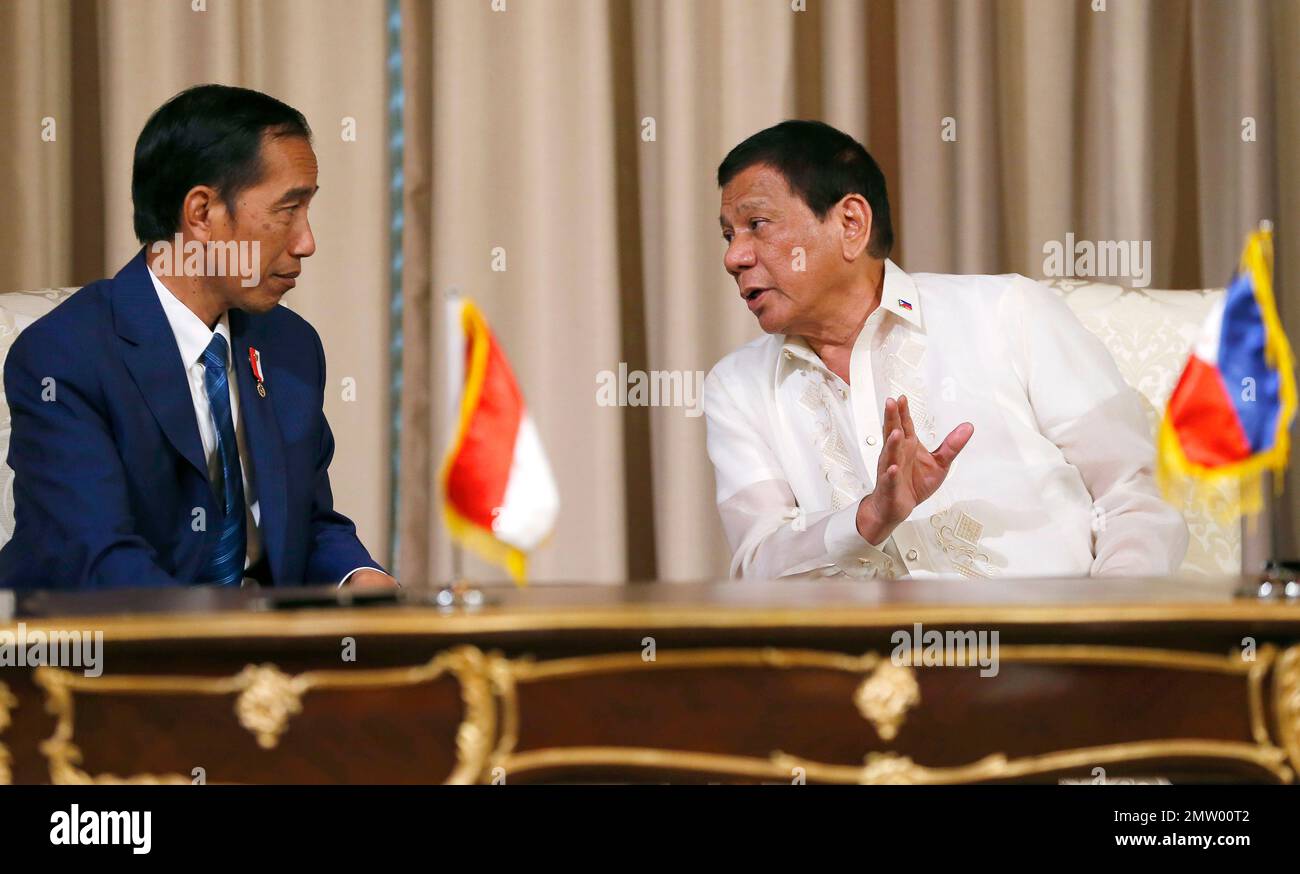 Philippine President Rodrigo Duterte, right, gestures while talking ...