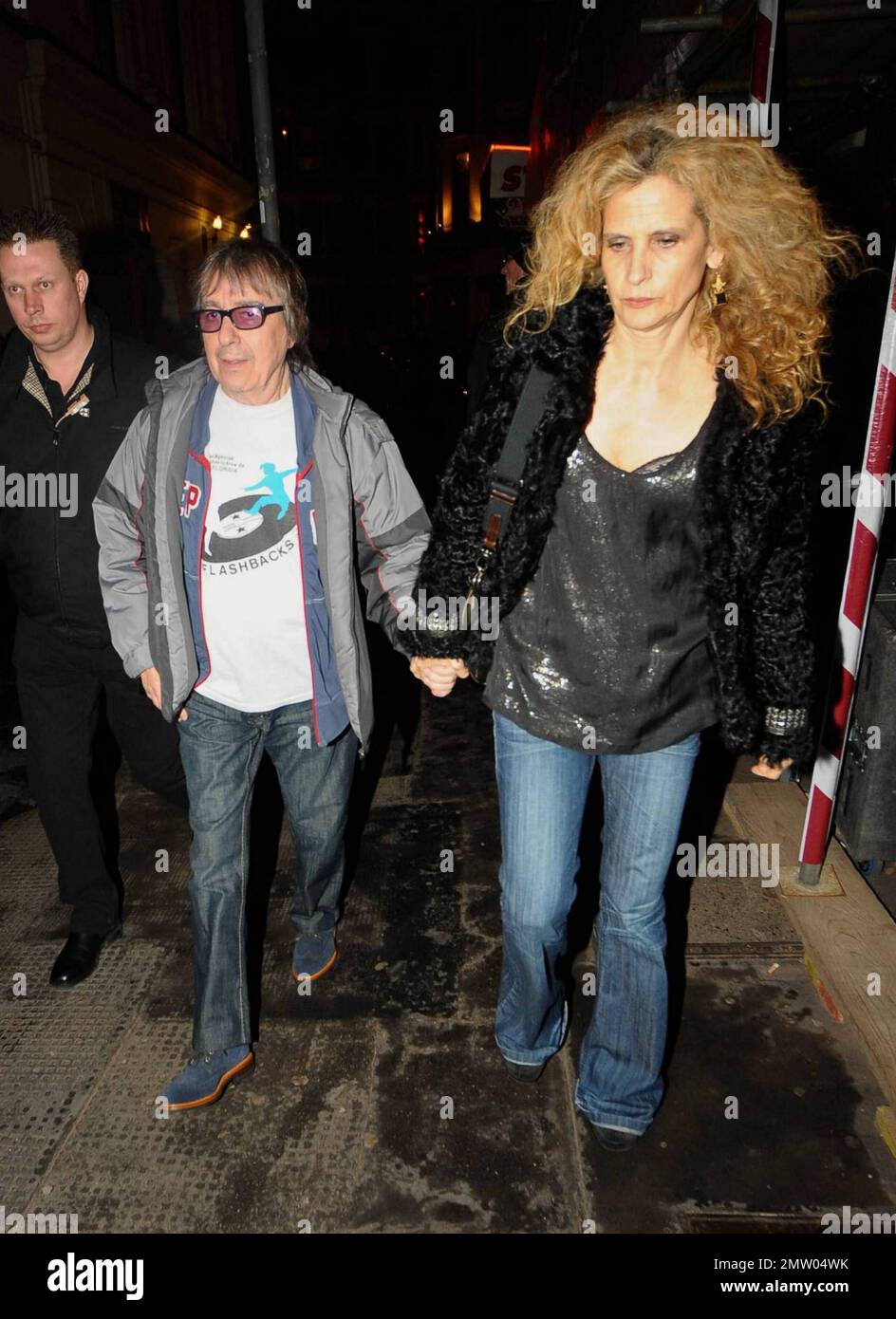 Former bassist for The Rolling Stones Bill Wyman and wife Suzanne Accosta hold hands as they arrive at the West End's Ambassadors Theatre for an intimate one-night only concert launching the tribute album Boogie 4 Stu.  The album was created by Ben Waters in memory of the late Ian Stewart (aka Stu), co-founder of The Rolling Stones, who died from a heart attack at the age of 47 in 1985.  Proceeds from the album will go to the British Heart Foundation. London, UK. 03/09/11. Stock Photo