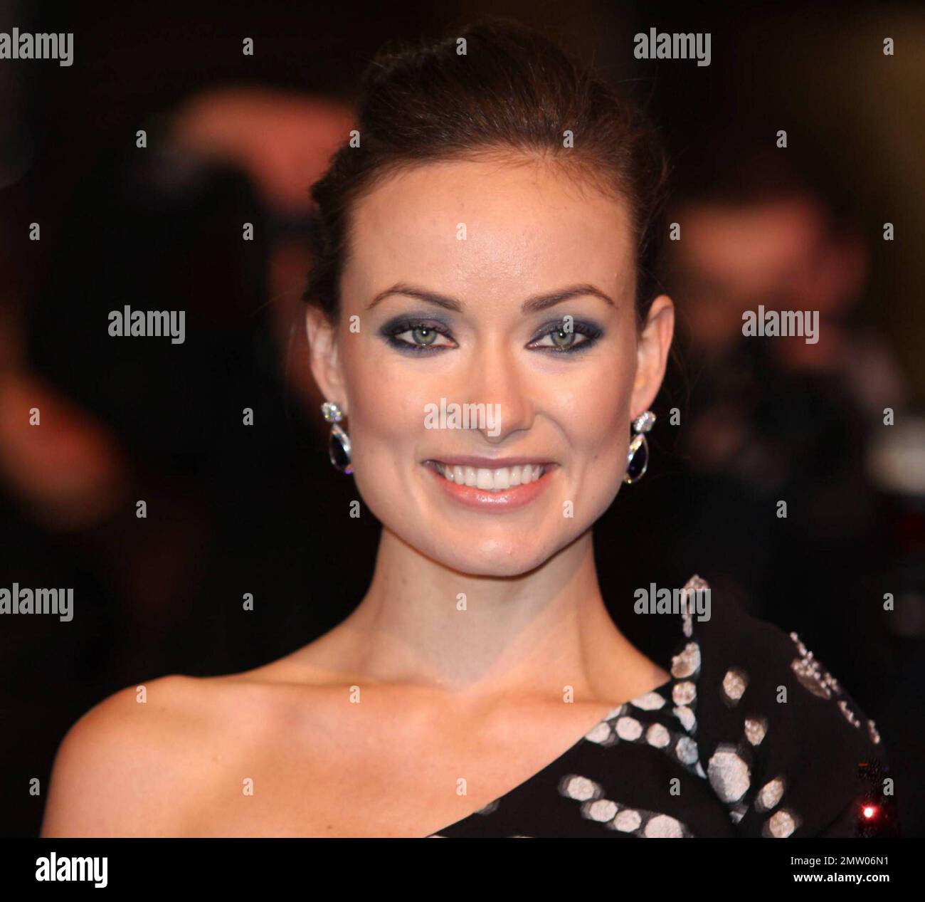 Olivia Wilde looks fabulous in a patterned cocktail dress and black nylons  as she arrives at the UK premiere of "TRON: Legacy" held at Empire  Leicester Square. London, UK. 12/05/10 Stock Photo -