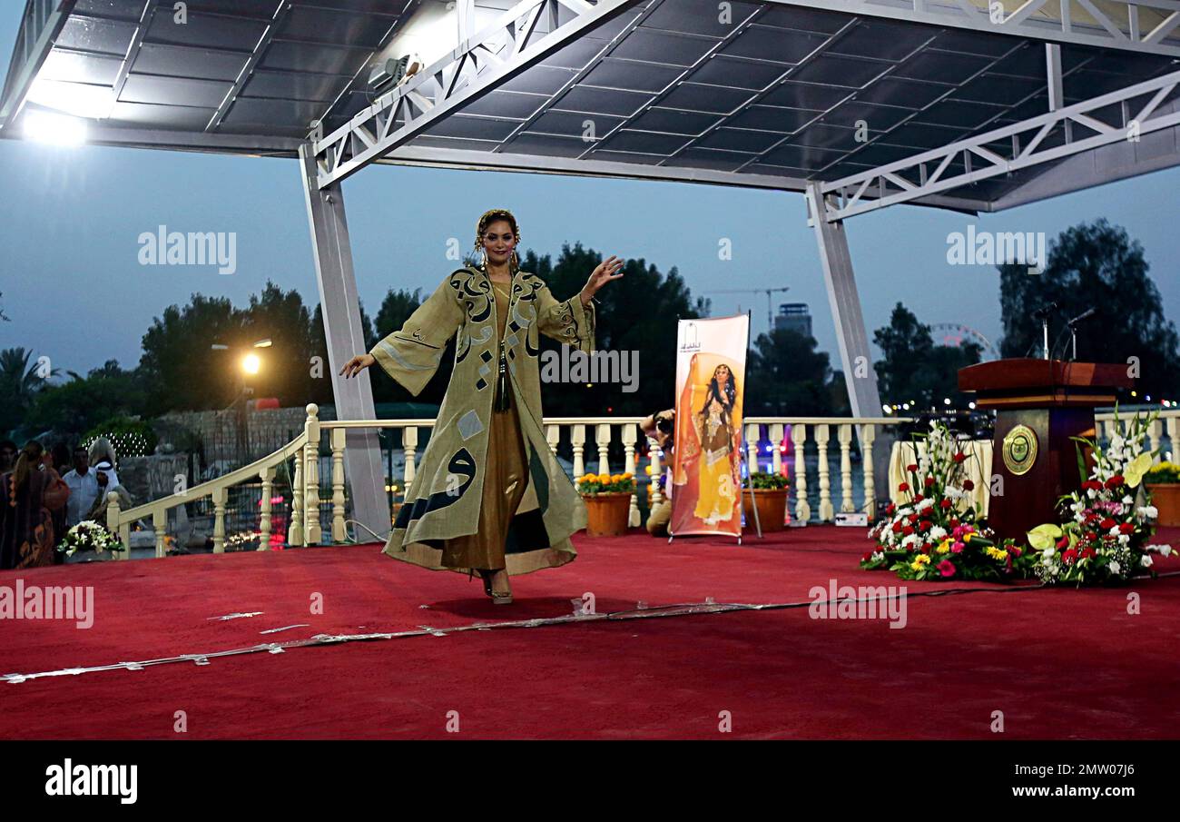 A model dressed in a traditional Iraqi folk costume during a flower
