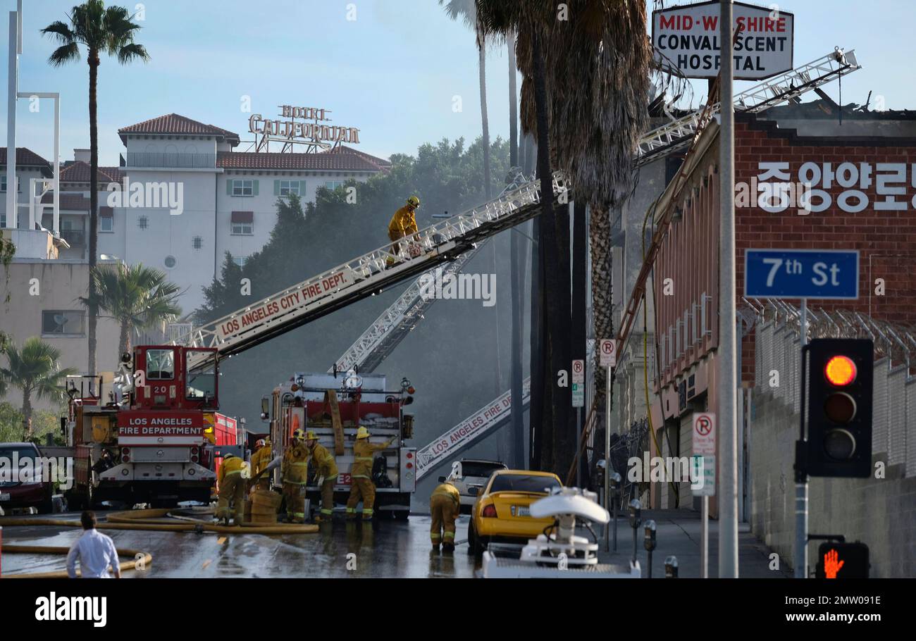 Los Angeles fire department firefighters finish extinguishing a fire at ...