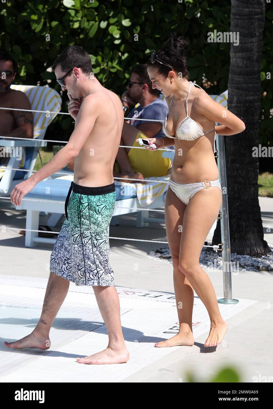 X Factor' judge Tulisa Contostavlos was spotted in Miami Beach showing off  her figure in a silver bikini in company of long time friend and personal  assistant Gareth Varey. The pair landed