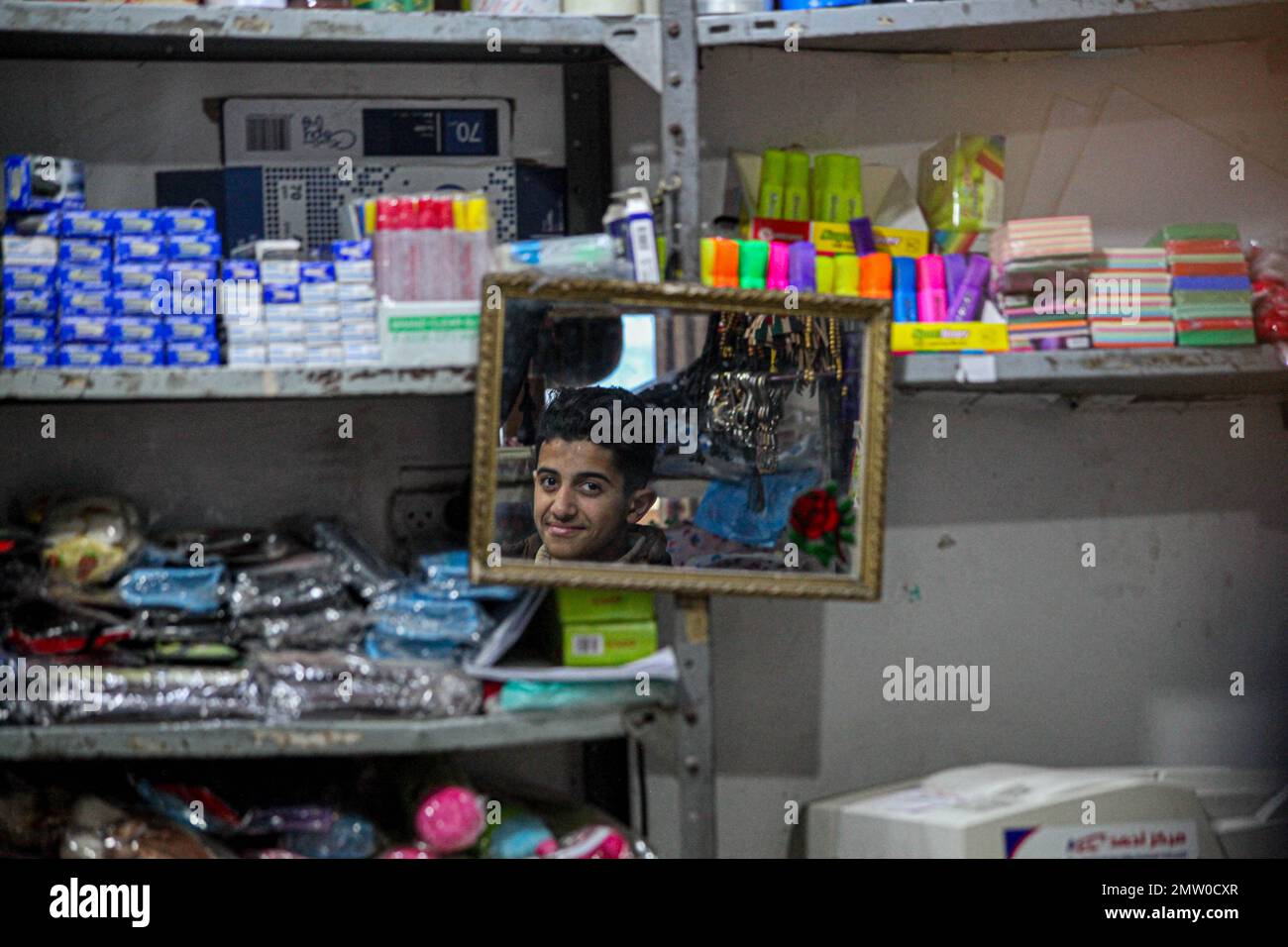 Palestinian child looks through mirror while shopping at a local market in the Jabalia refugee camp during inclement weather in Gaza City, February 1, 2023. Photo by Ramez Habboub/ABACAPRESS.COM Stock Photo