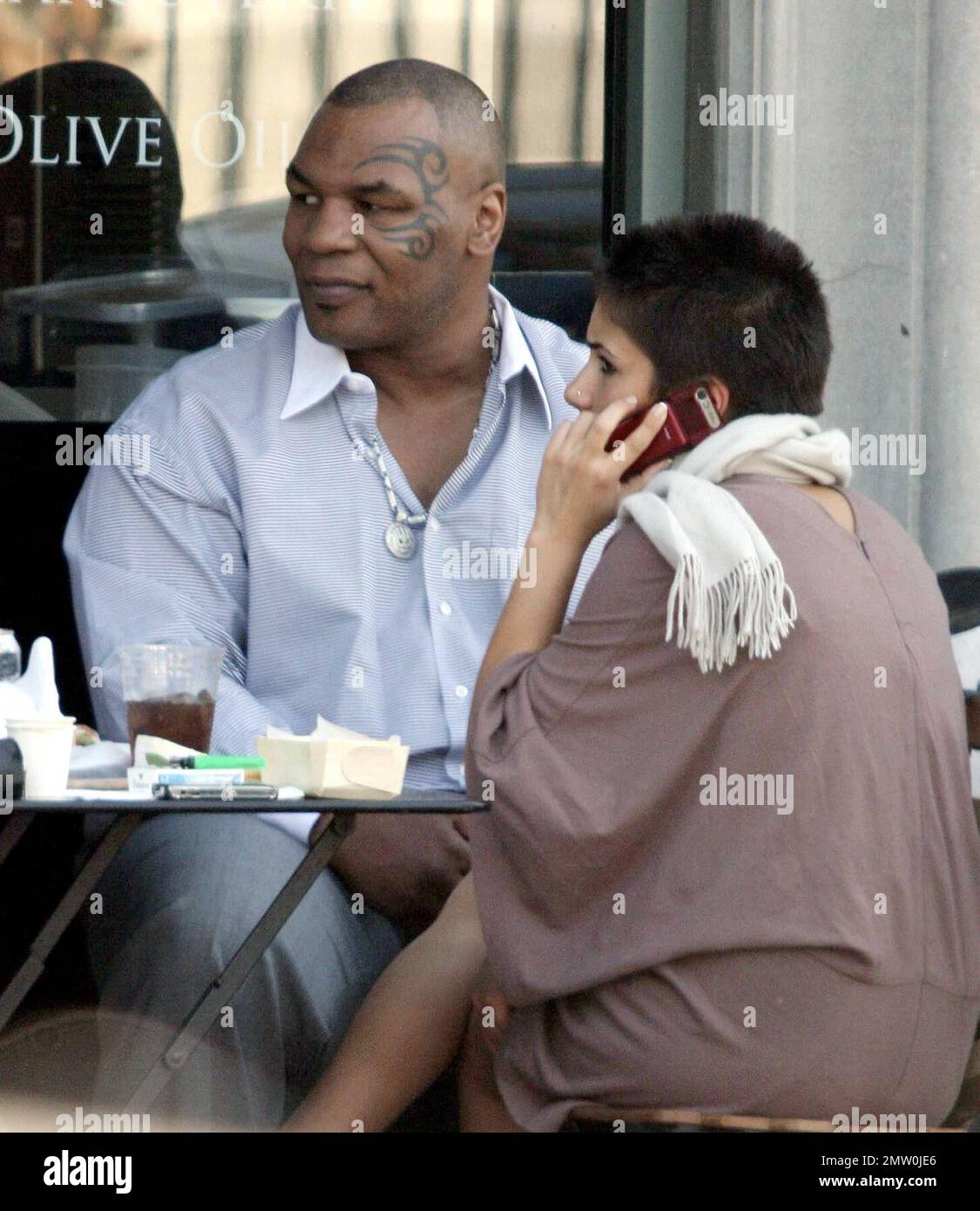 Mike Tyson lunches with two female friends at Joans On Third. Tyson is reportedly in talks for a potential third boxing rematch with Evander Holyfield. Tyson was disqualified during their last bout in 1997 when Tyson  took a bite out Holyfield's ear. Los Angeles, Ca. 3/5/08. Stock Photo