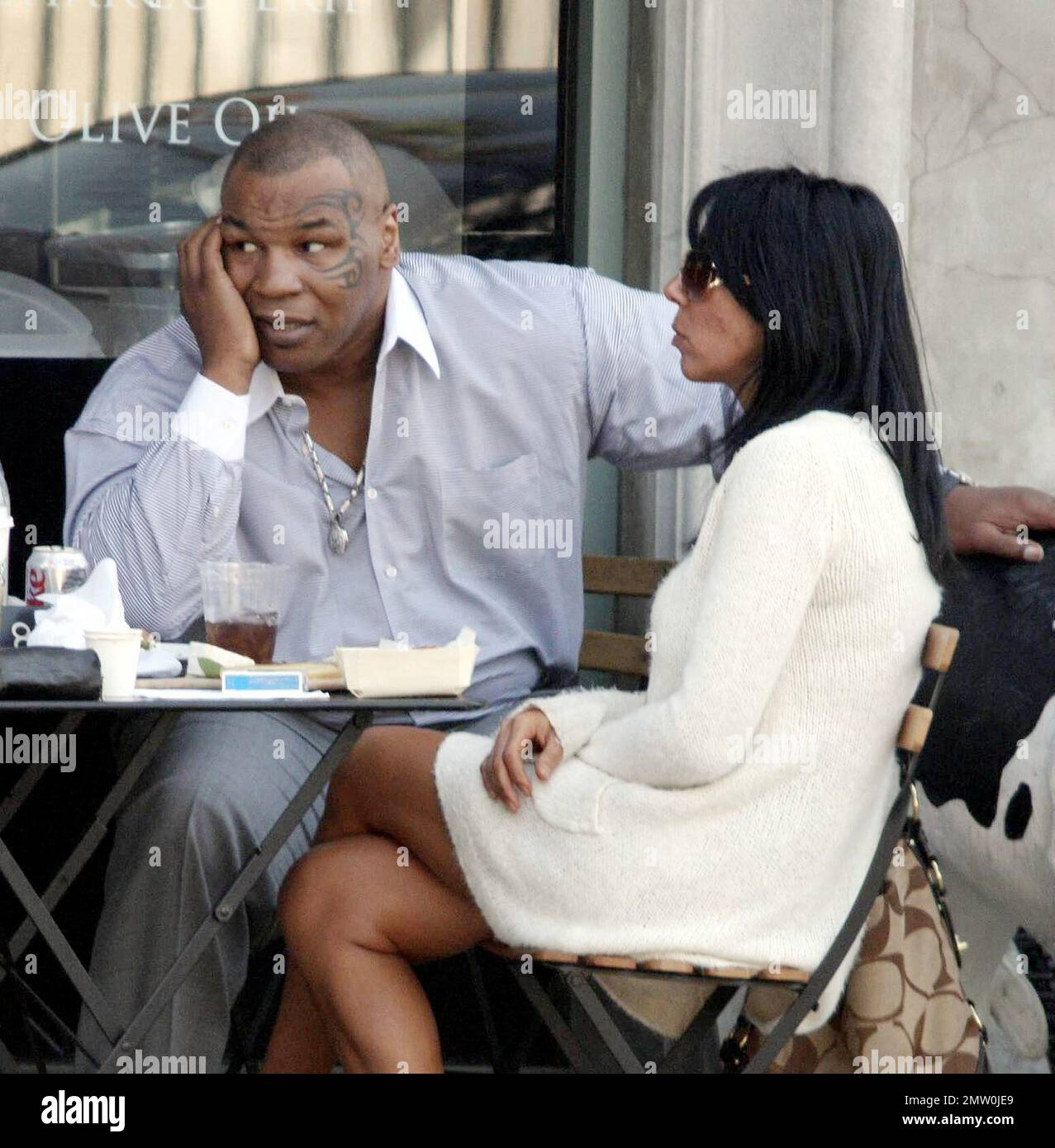 Mike Tyson lunches with two female friends at Joans On Third. Tyson is reportedly in talks for a potential third boxing rematch with Evander Holyfield. Tyson was disqualified during their last bout in 1997 when Tyson  took a bite out Holyfield's ear. Los Angeles, Ca. 3/5/08. Stock Photo