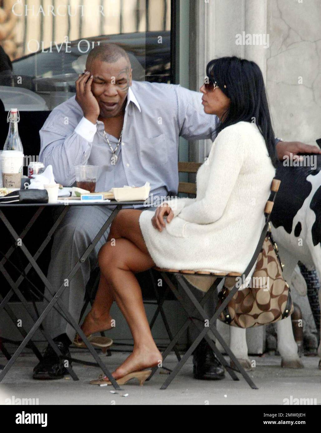 Mike Tyson lunches with two female friends at Joans On Third. Tyson is reportedly in talks for a potential third boxing rematch with Evander Holyfield. Tyson was disqualified during their last bout in 1997 when Tyson  took a bite out Holyfield's ear. Los Angeles, Ca. 3/5/08. Stock Photo