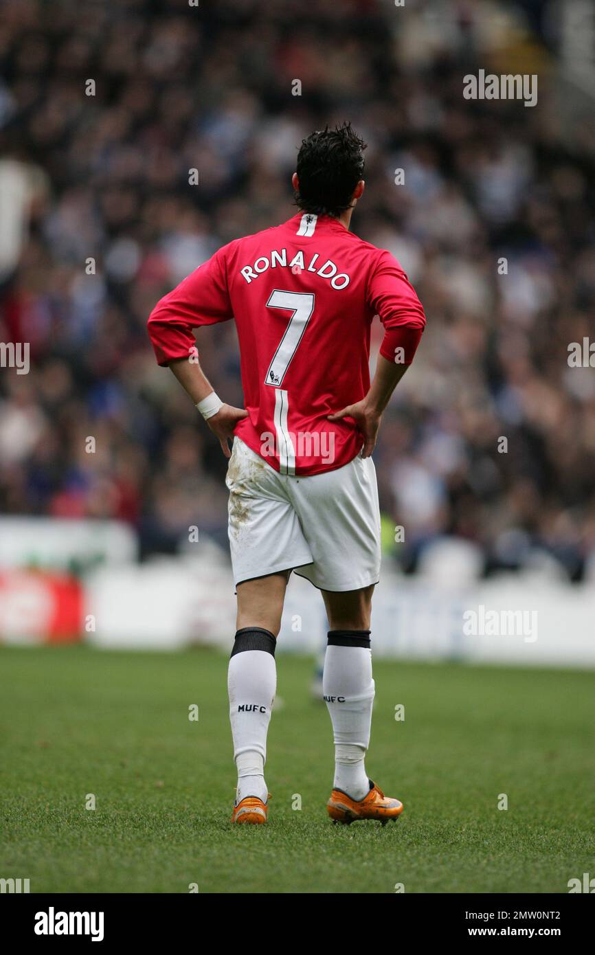 Back view of Cristiano Ronaldo with hands on hip in Manchester United kit showing name and number 7 playing in the premier league against Reading. Archive 19th January 2008. at the Madejski Stadium Reading.This image is bound by Dataco restrictions on how it can be used. EDITORIAL USE ONLY No use with unauthorised audio, video, data, fixture lists, club/league logos or “live” services. Online in-match use limited to 120 images, no video emulation. No use in betting, games or single club/league/player publications Stock Photo