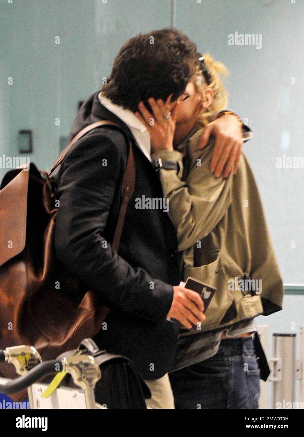 EXCLUSIVE!! Actress Uma Thurman, greeted off again, on again fiance Arpad Busson with a kiss at Miami Intl Airport arrivals. The couple called off their engagement in December 2009 after two years of dating but have obviously rekindled their romance.  Thurman has been filming her new movie, 'Bel Ami' recently opposite 'Twilight' star Robert Pattinson.  Miami, FL.  03/25/2010   . Stock Photo