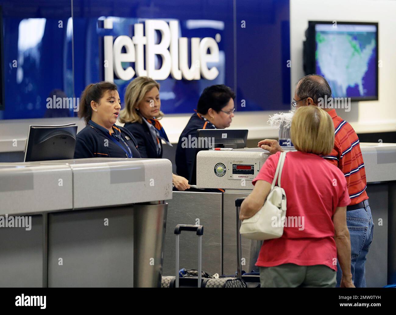 In this Wednesday, Oct. 26, 2016, photo, JetBlue Airways ticket agents ...