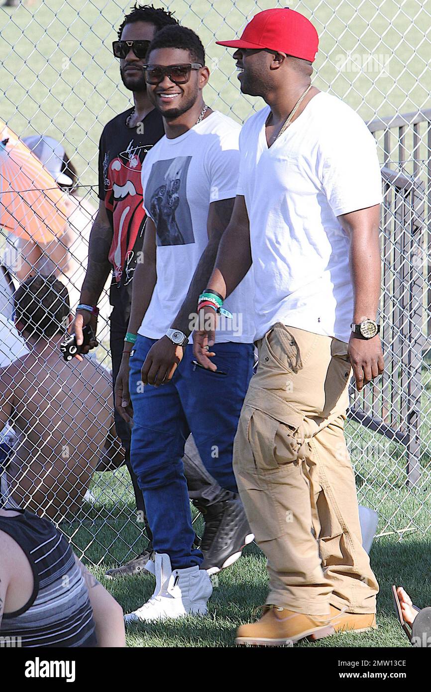 Wearing blue pants Usher walks with friends and is all smiles on day three  of the Coachella Music and Arts Festival. Indio, CA. 04/17/11 Stock Photo -  Alamy