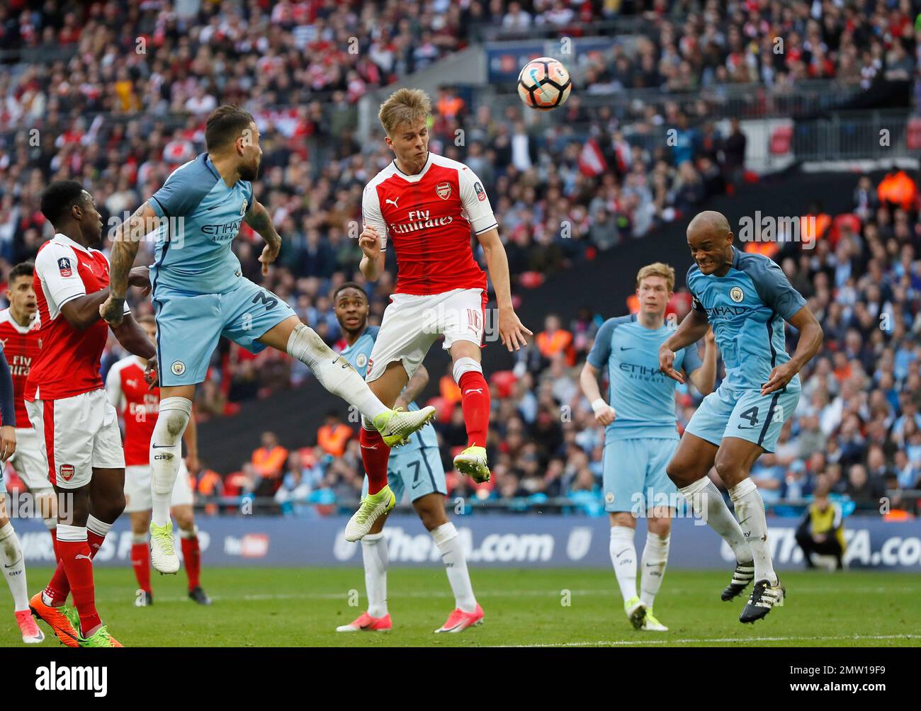 Arsenal's Rob Holding, center, attempts a header on goal during the ...
