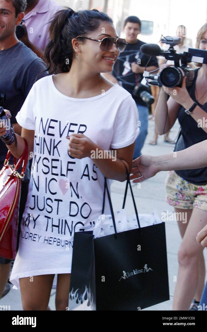 Vanessa White of the girl group The Saturdays spends a day shopping on  Robertson Blvd. Wearing a t-shirt dress with a quote from Audrey Hepburn  that reads, I never think of myself