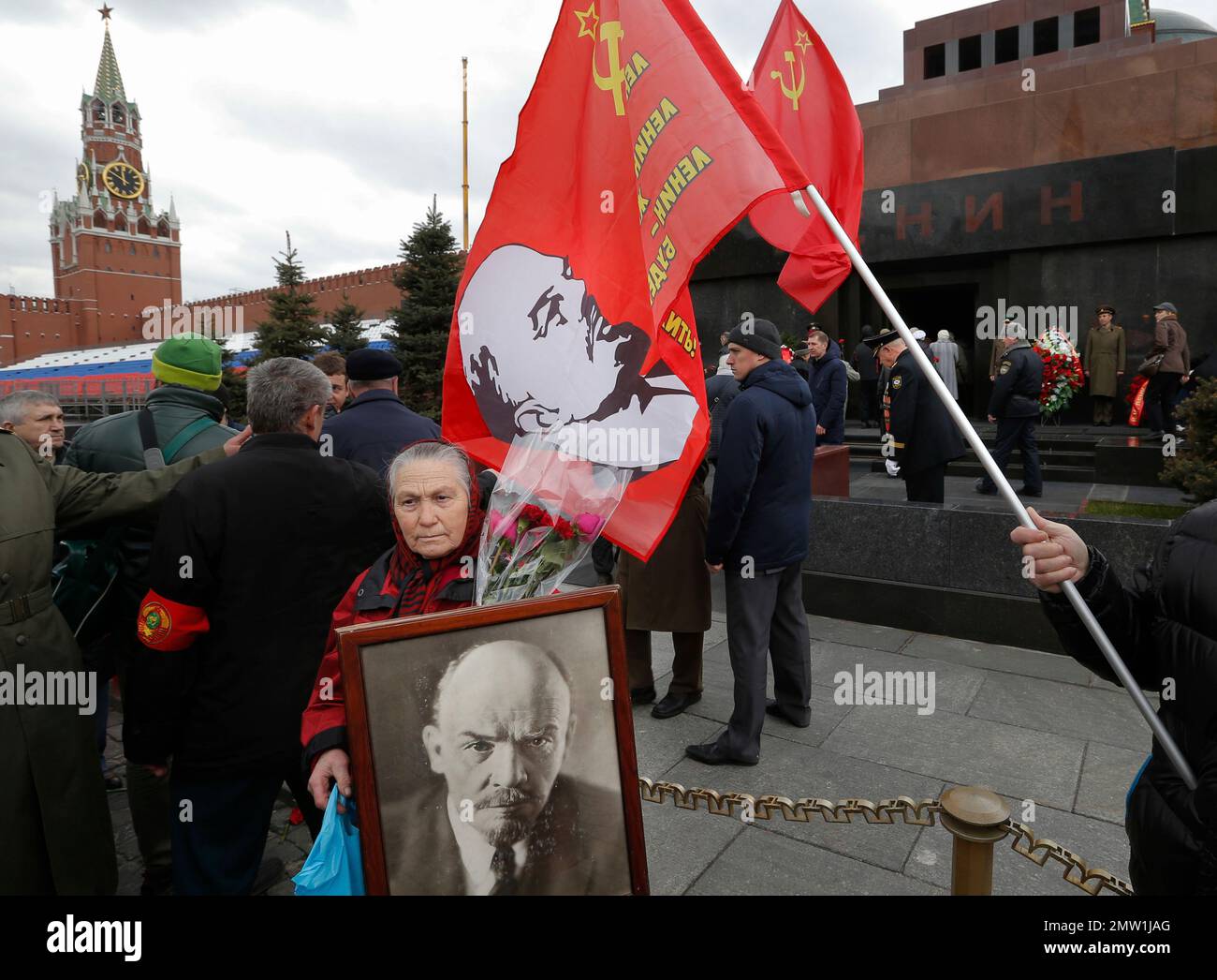 Russian communists and supporters queue, with their flags, to visit the ...