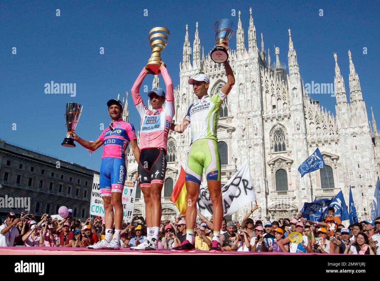 FILE - In this May 29, 2011 file photo, from left, second placed Michele  Scarponi of Italy, winner Alberto Contador of Spain and third placed  Vincenzo Nibali of Italy hold their trophies
