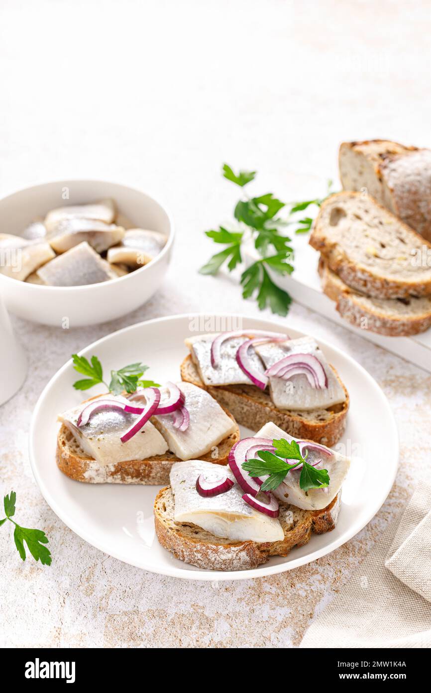 Herring sandwich. Open sandwiches with whole grain bread, herring and onion Stock Photo