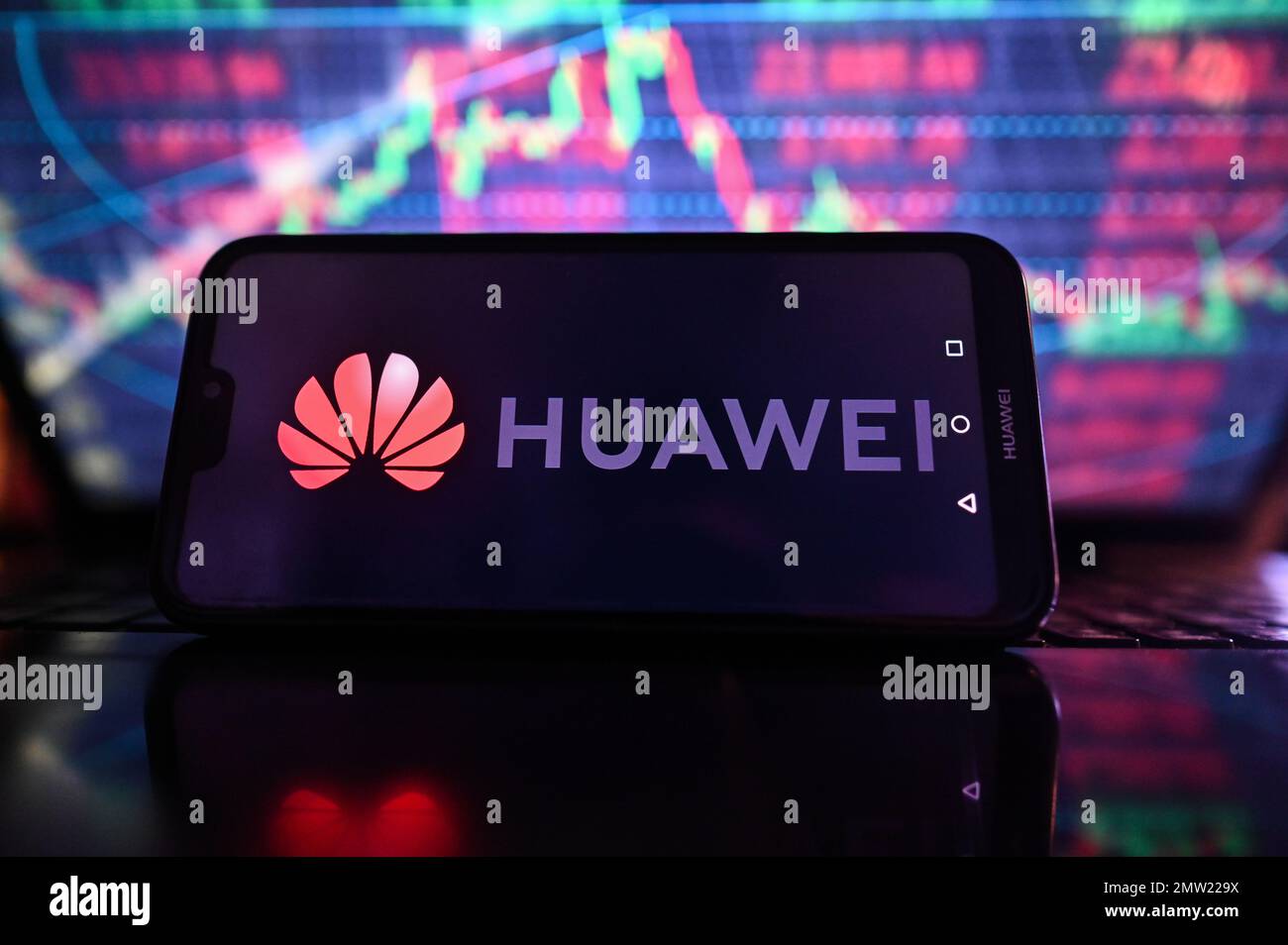 In this photo illustration, the Huawei logo is displayed on a smartphone  with stock market exchange in the background. (Photo by Omar Marques / SOPA  Images/Sipa USA Stock Photo - Alamy