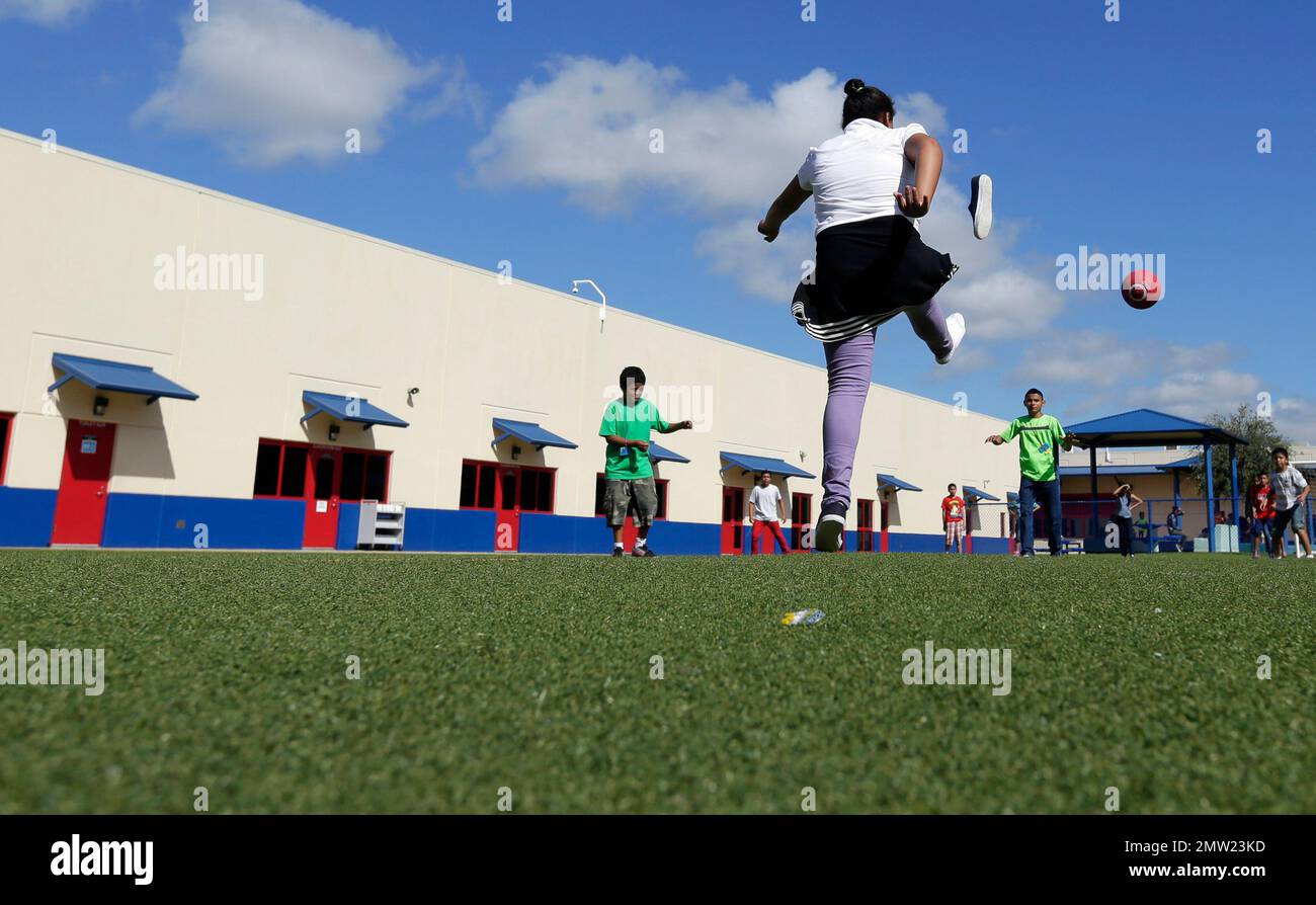 FILE In this Sept. 10, 2014, file photo, children play kickball at