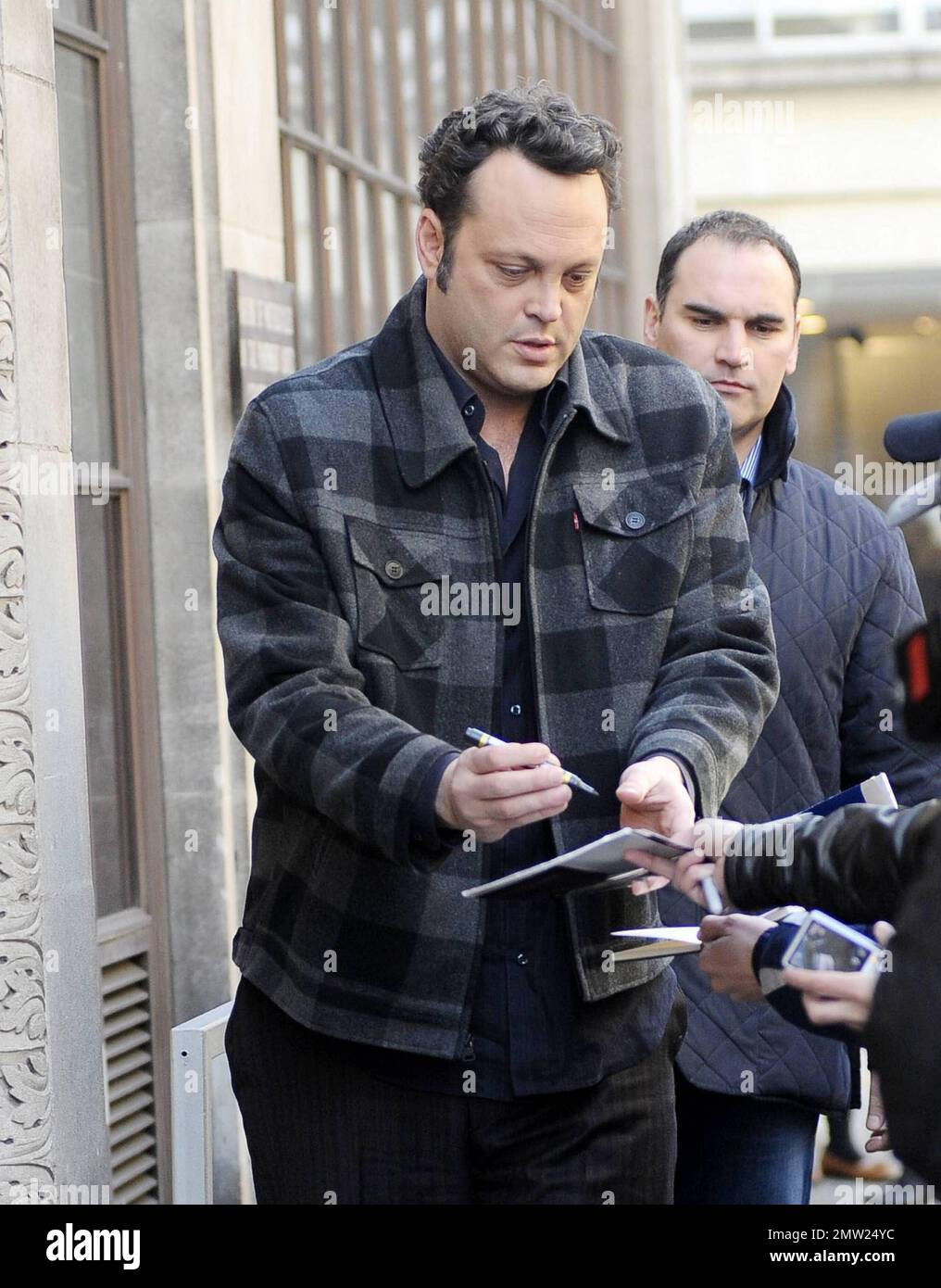 New father Vince Vaughn signs autographs for fans as he arrives
