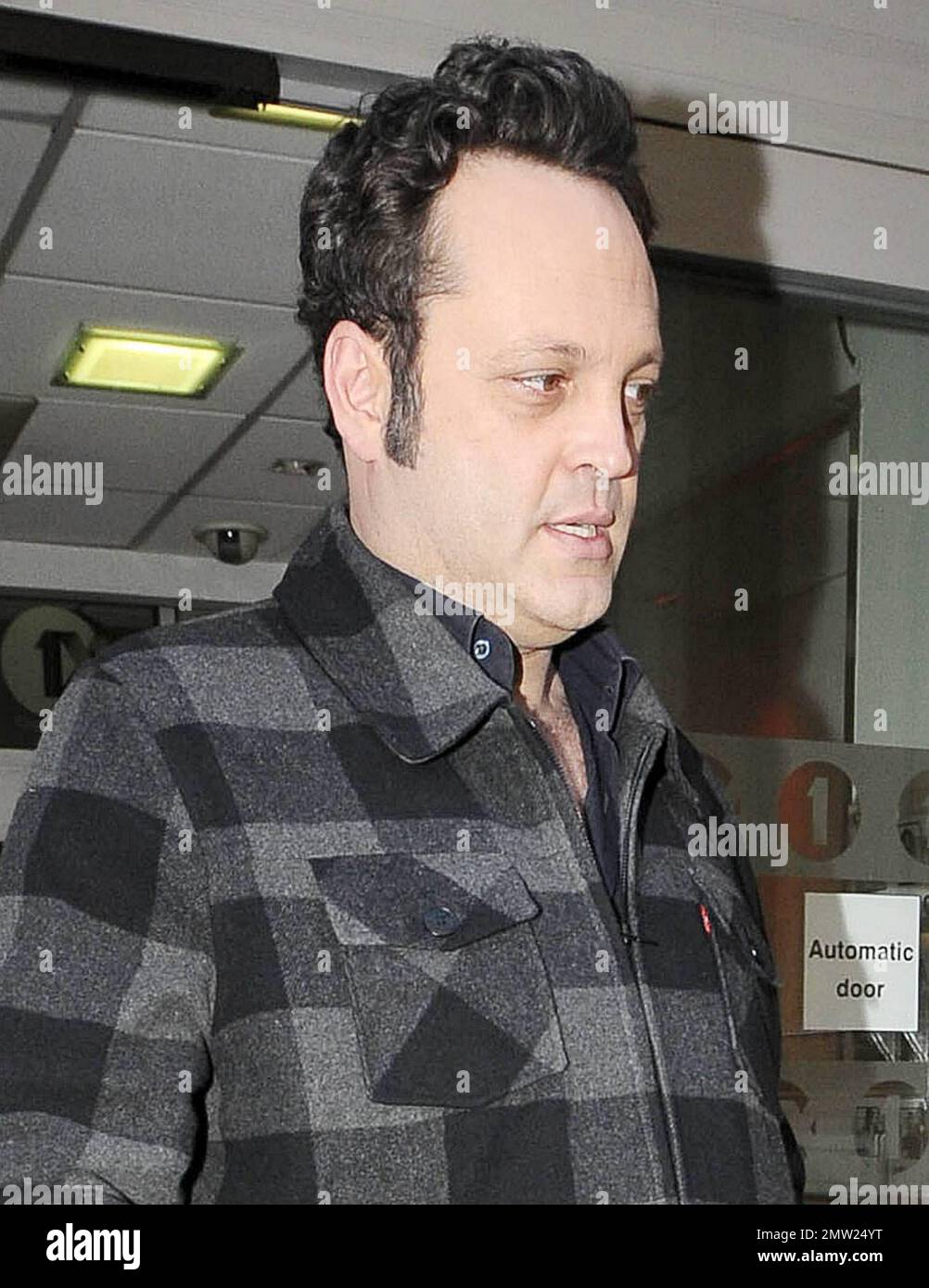 New father Vince Vaughn signs autographs for fans as he arrives and later leaves the studios of BBC Radio where he promoted his new movie "The Dilemma", co-starring Jennifer Connelly and Winona Ryder.  Vaughn, whose daughter Locklyn Kyla Vaughn turned one month old yesterday, appeared happy to greet his fans despite looking a little tired.  Winona Ryder has said of Vaughn, 'I describe Vince as this volcano of energy and great ideas and so generous. He will come up with a great line and he will be like, "Hey you should say that."Ê It was such fun working with him, most of my scenes were with hi Stock Photo