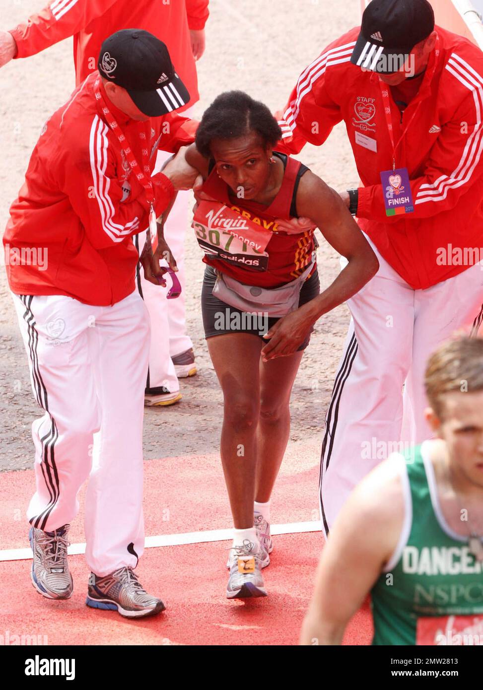 A runner falls at the finish line following the 2011 Virgin London