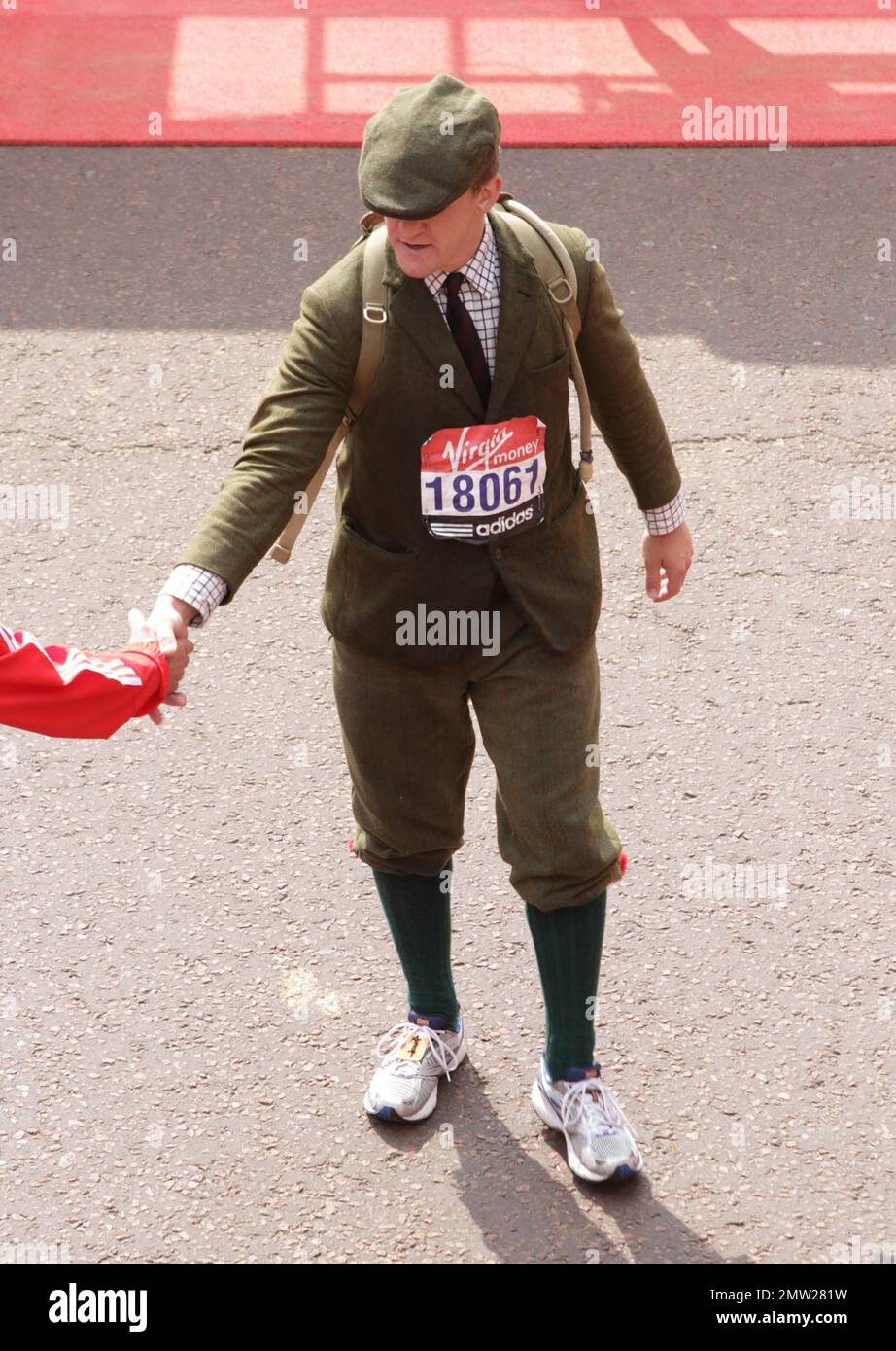 A runner in costume at the finish line following the 2011 Virgin London Marathon. London, UK. 04/17/11. Stock Photo