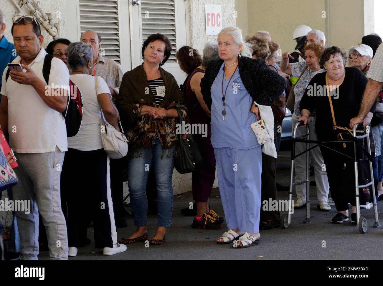 People wait in line for an application to apply for low elderly