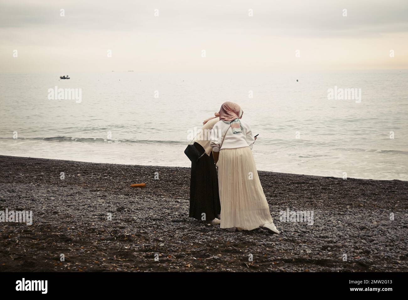 Young women on the shore of the sea, on Amalfi Coast , Province of Salerno, Campania, Italy Stock Photo