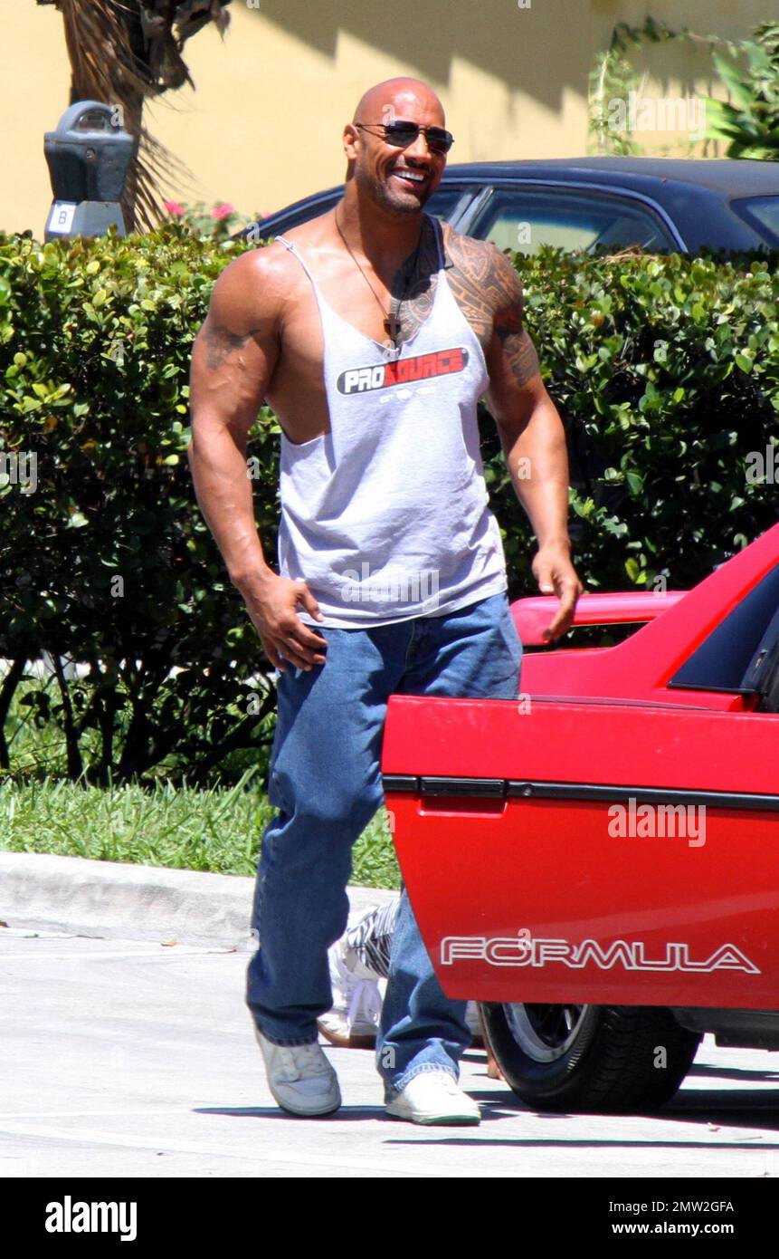 The Rock Aka Dwayne Johnson And Mark Wahlberg Film Scenes On Location For Their New Movie No Pain No Gain The Two Bulky Actors And A Co Star Barely Fit As They Piled Into A Vintage Pontiac Fiero During The Shoot The Rock Also Flexed Showing Off His Huge Build For Photographers Miami Fl 24th April 2012 2MW2GFA 