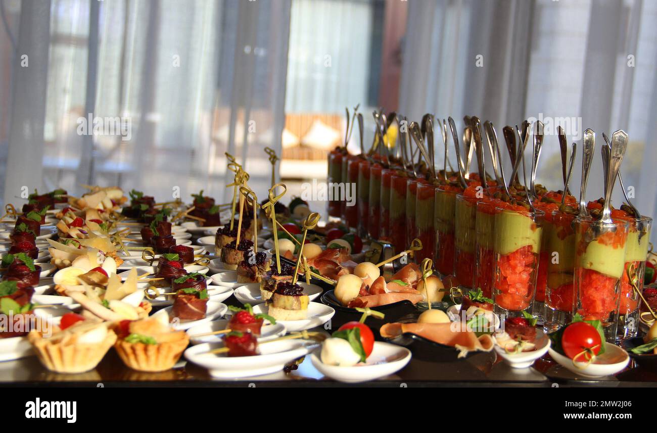 Delicious snacks and appetizers in glass cups on a banquet table Stock