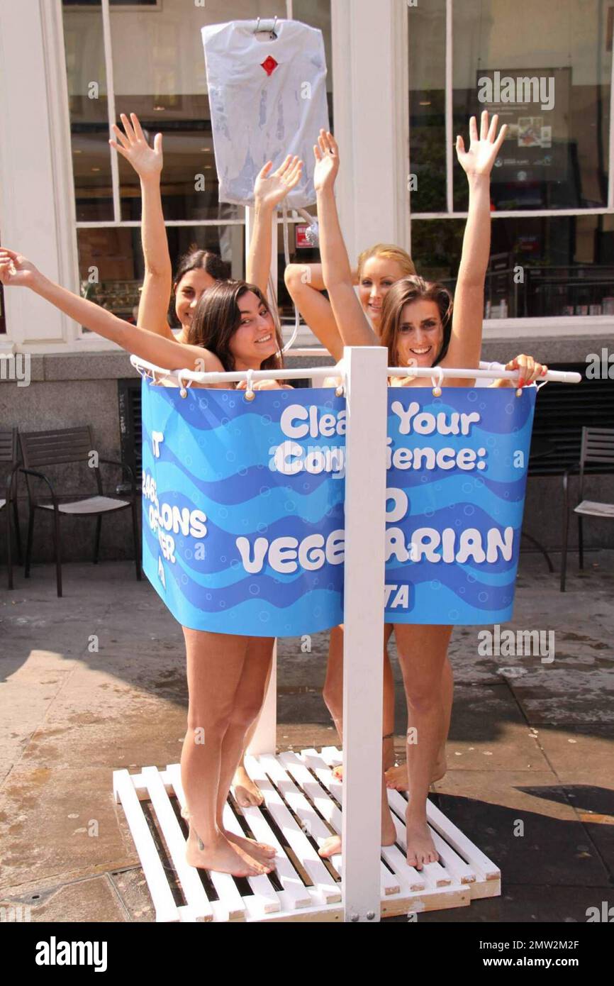 Seemingly nude models pose together in an outdoor shower for PETA's Warm Up To Earth Day event. Encourageing Vegetarianism, the slogans on the outside of the shower curtain read 'CLEAN YOUR CONSCIENCE: GO VEGETARIAN' and '1 LB. OF MEAT = 2,463 GALLONS OF WATER.' Smithfields Market. London, UK. 4/20/09.       . Stock Photo