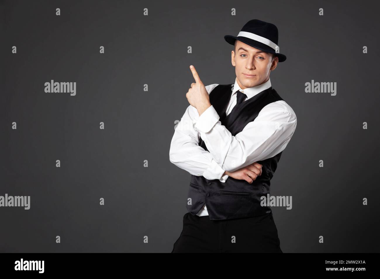 Men's Beauty, Fashion. Retro Style. Handsome Man In An Expensive  Three-piece Suit, A Cap And Leather Gloves On A Black Background. Mafia  Man. Stock Photo, Picture and Royalty Free Image. Image 158258662.