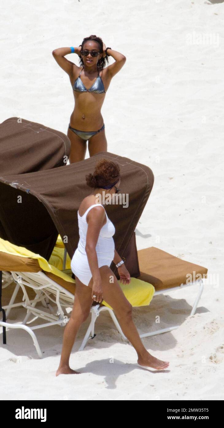 EXCLUSIVE!! R&B singer Whitney Houston, wearing a white swimsuit showing  off her fuller figure, enjoys an afternoon at Atlantis Paradise Island  beach with 17 year old daughter Bobbi Kristina and friends. Houston,