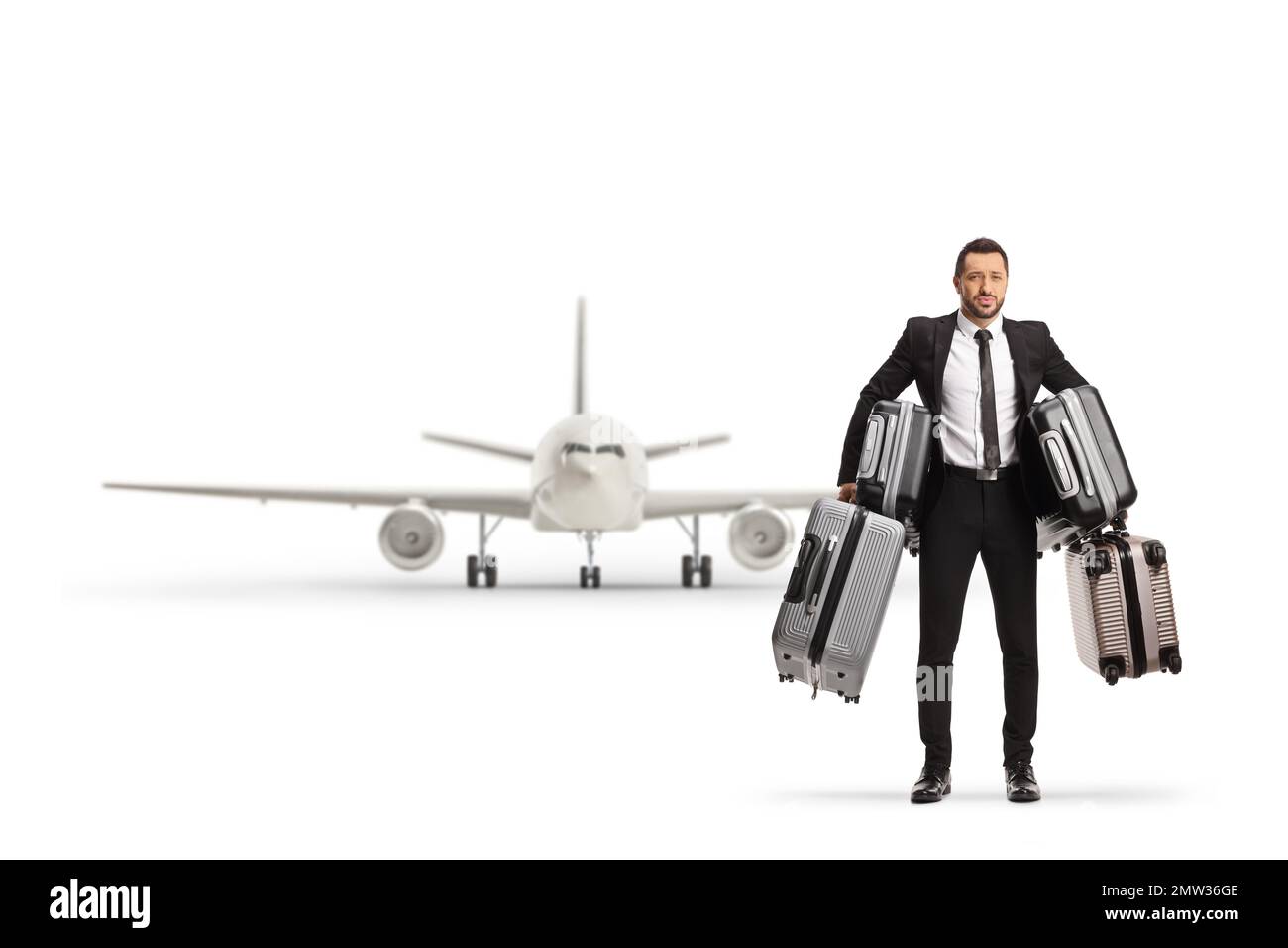 Full length portrait of a businessman holding many suitcases in front of an airplane isolated on